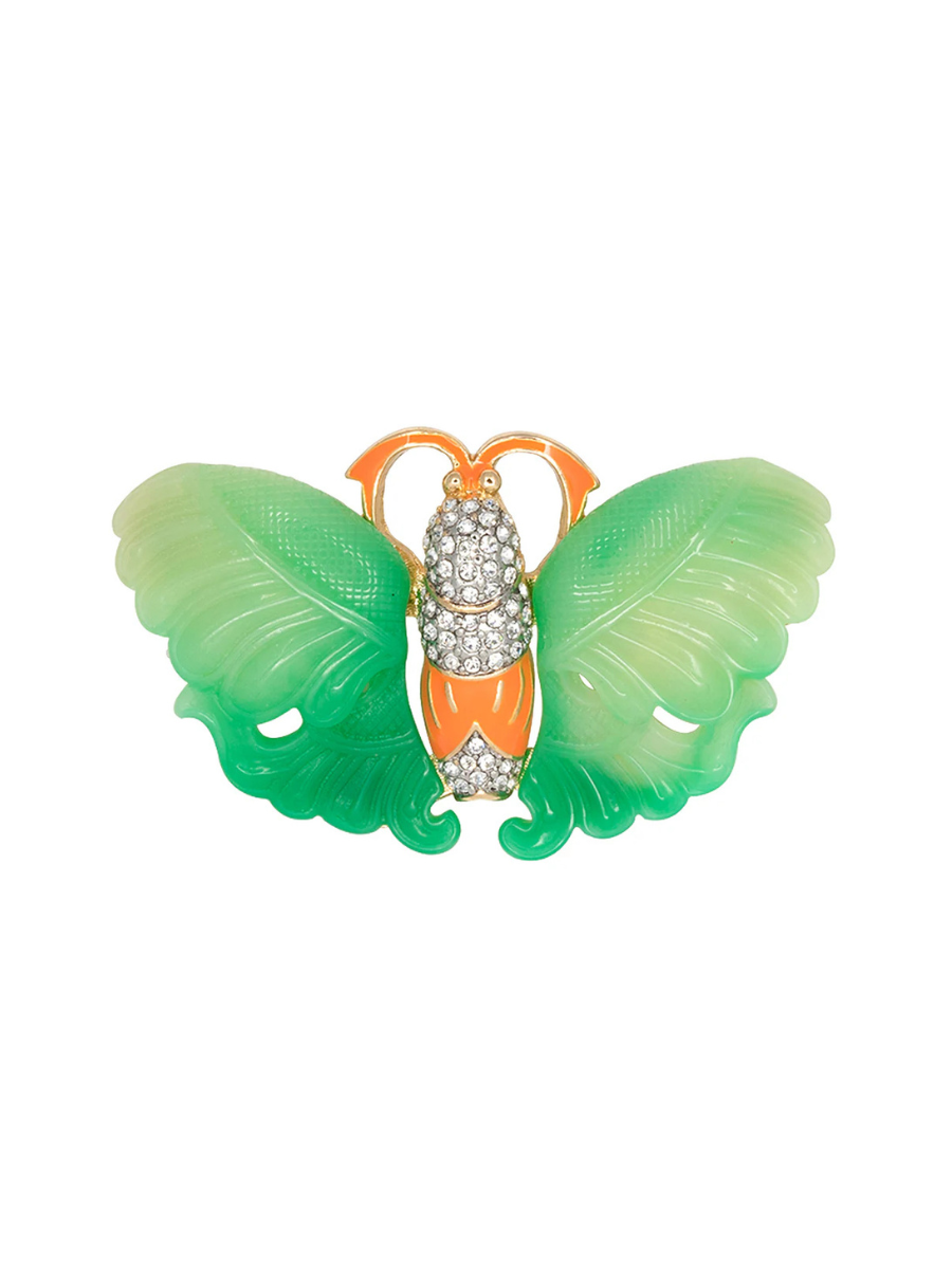 Butterfly-shaped brooch with green wings and orange body on a white background