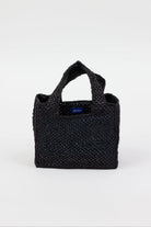 Black woven handbag with a visible brand logo on a white background
