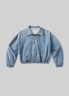 Light blue denim jacket on a gray background