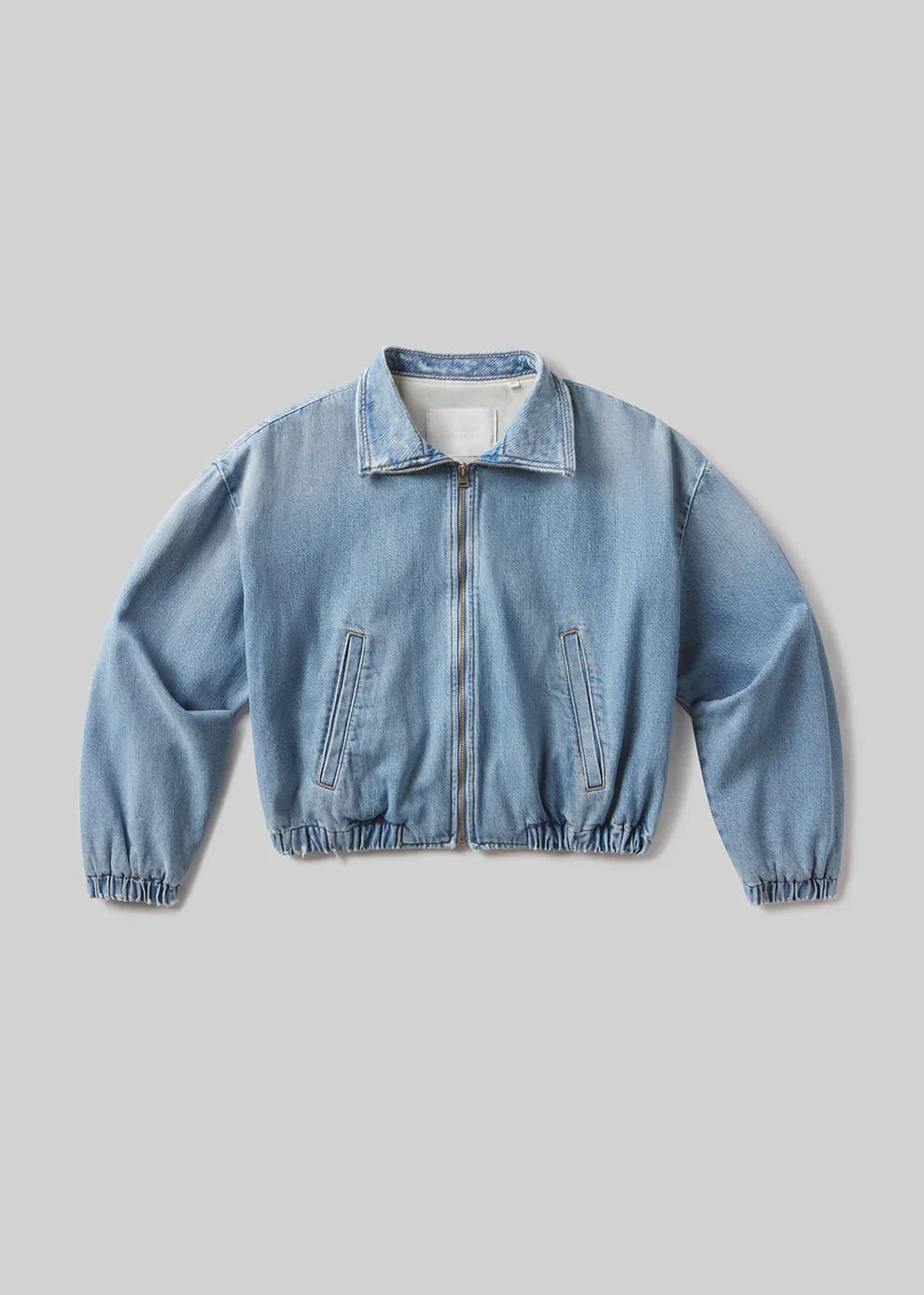 Light blue denim jacket on a gray background