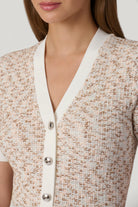 Close-up of a textured cardigan with a neutral background