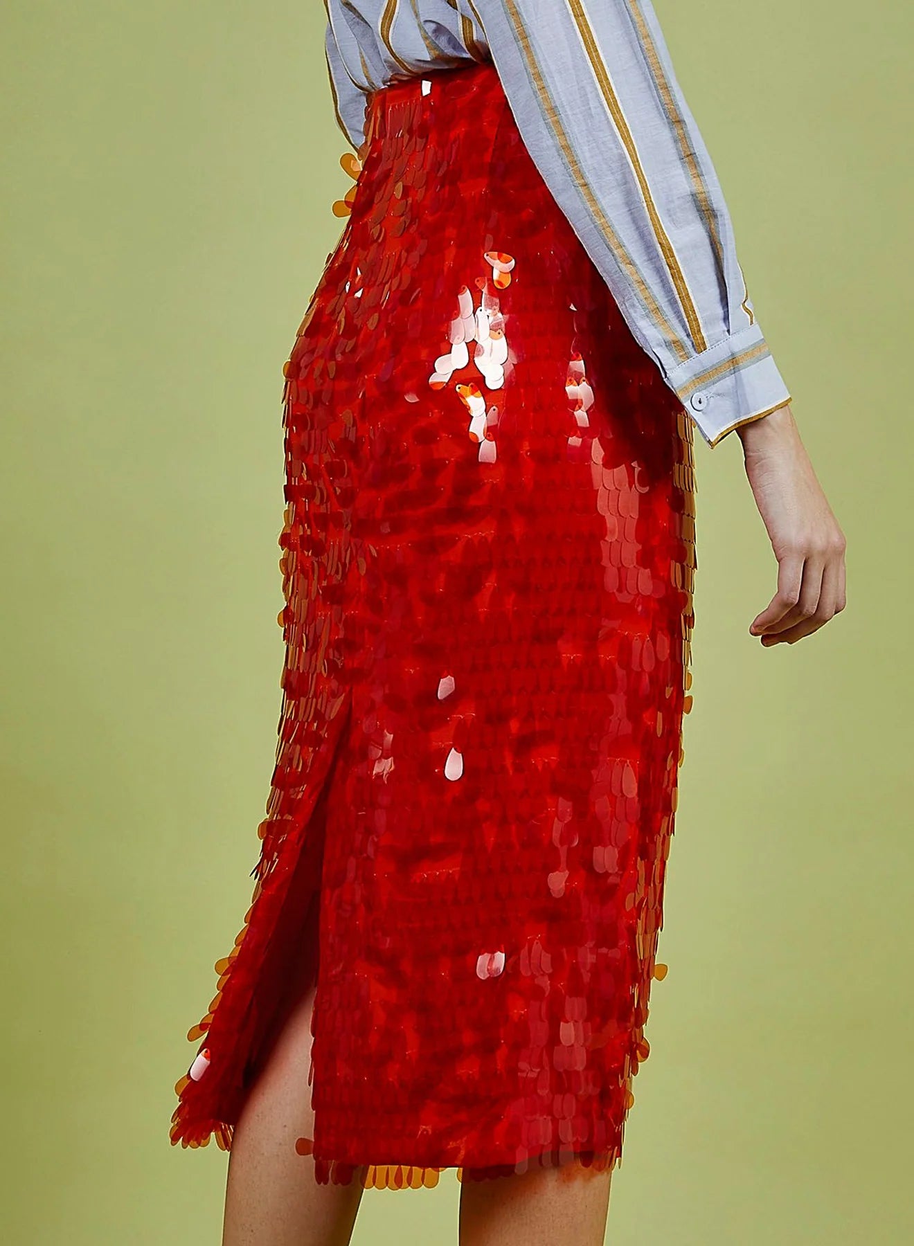 Red sequin skirt worn by a person on a green background