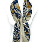 Decorative scarf with blue and yellow floral pattern on a white background