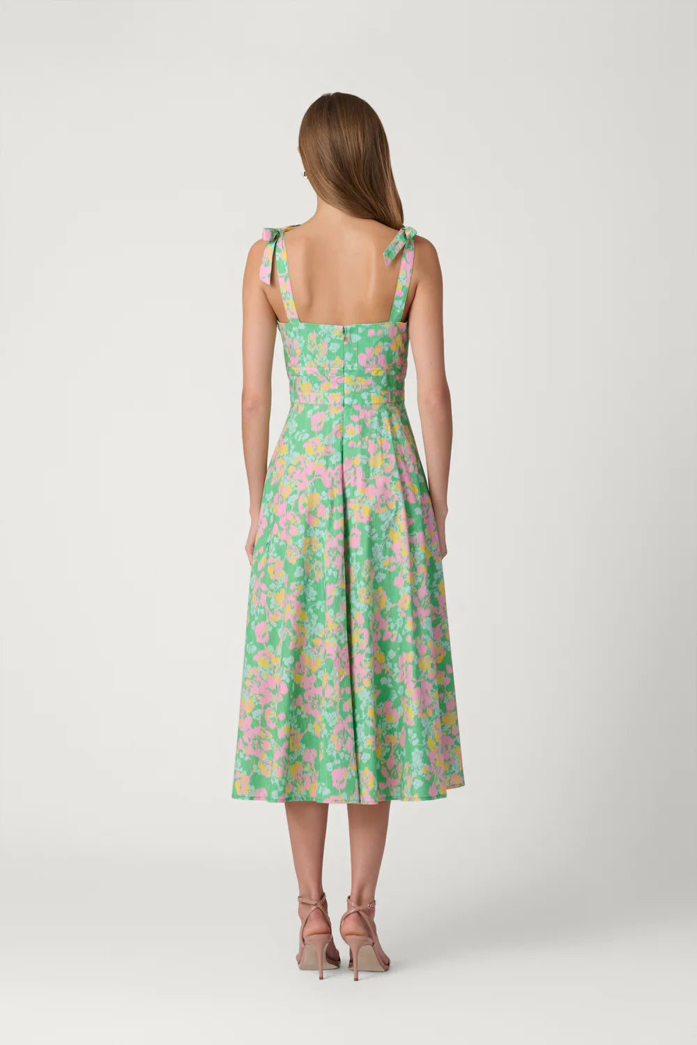 Woman wearing a floral dress on a white background