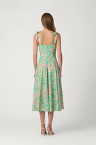 Woman wearing a floral dress on a white background