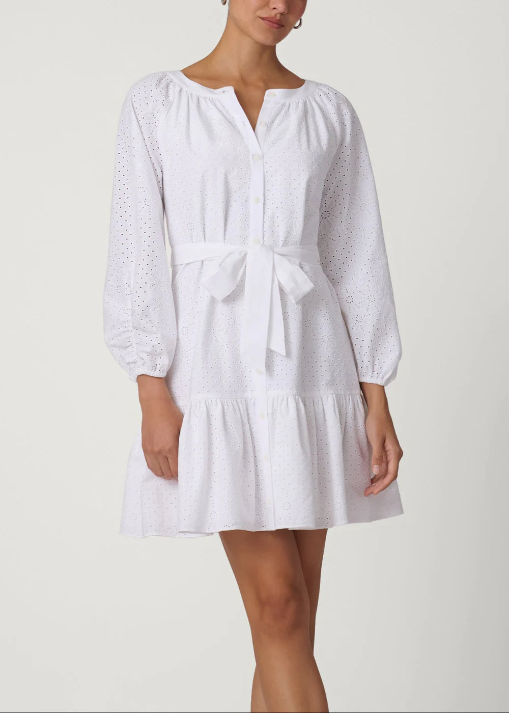 White dress with long sleeves and a belt on a white background