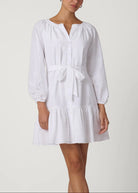 White dress with long sleeves and a belt on a white background