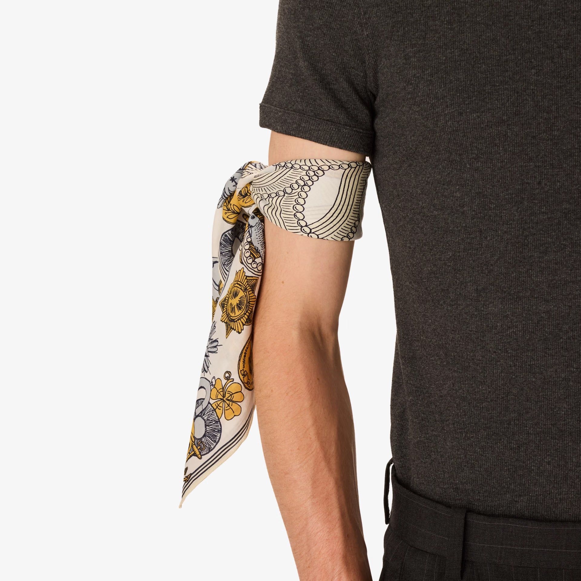 Person wearing a patterned arm scarf with a plain background