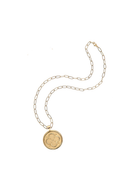 Gold necklace with a round pendant on a white background