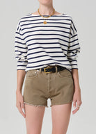 Person wearing a striped shirt and shorts on a plain background