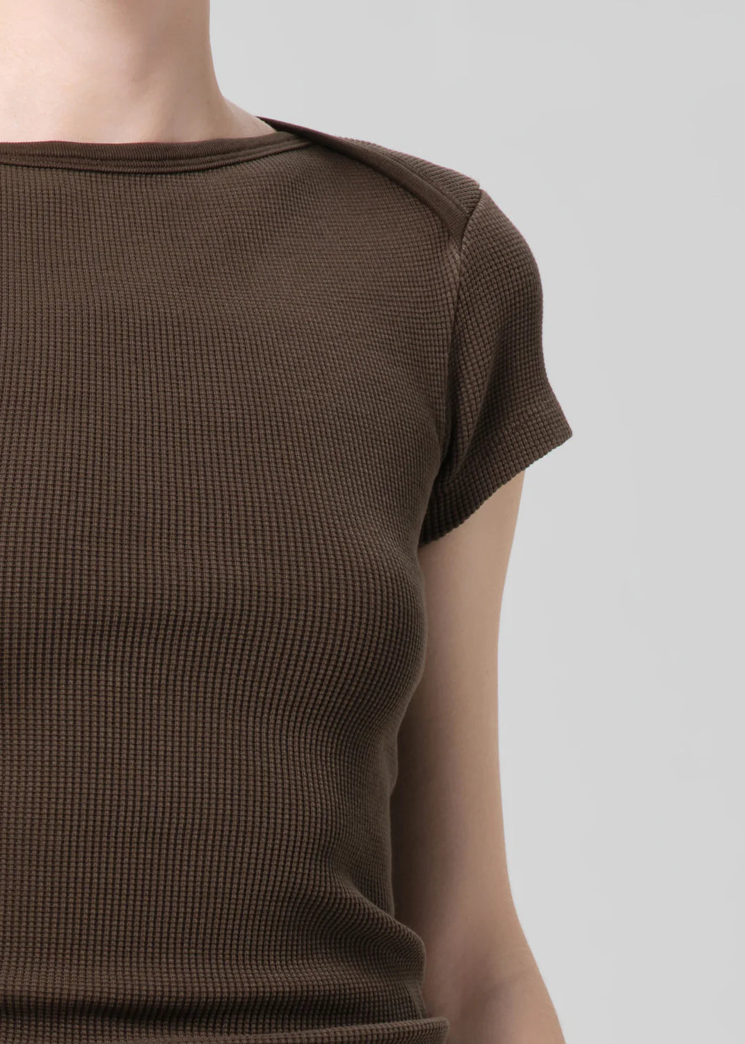 Brown textured dress on a plain background