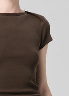 Brown textured dress on a plain background