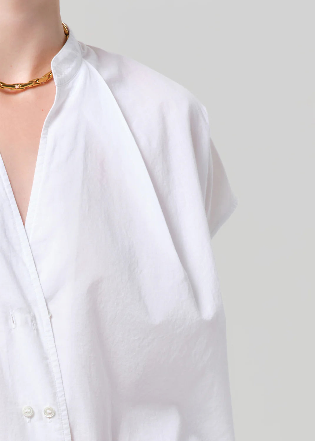 White shirt on a mannequin with a plain background