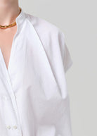 White shirt on a mannequin with a plain background