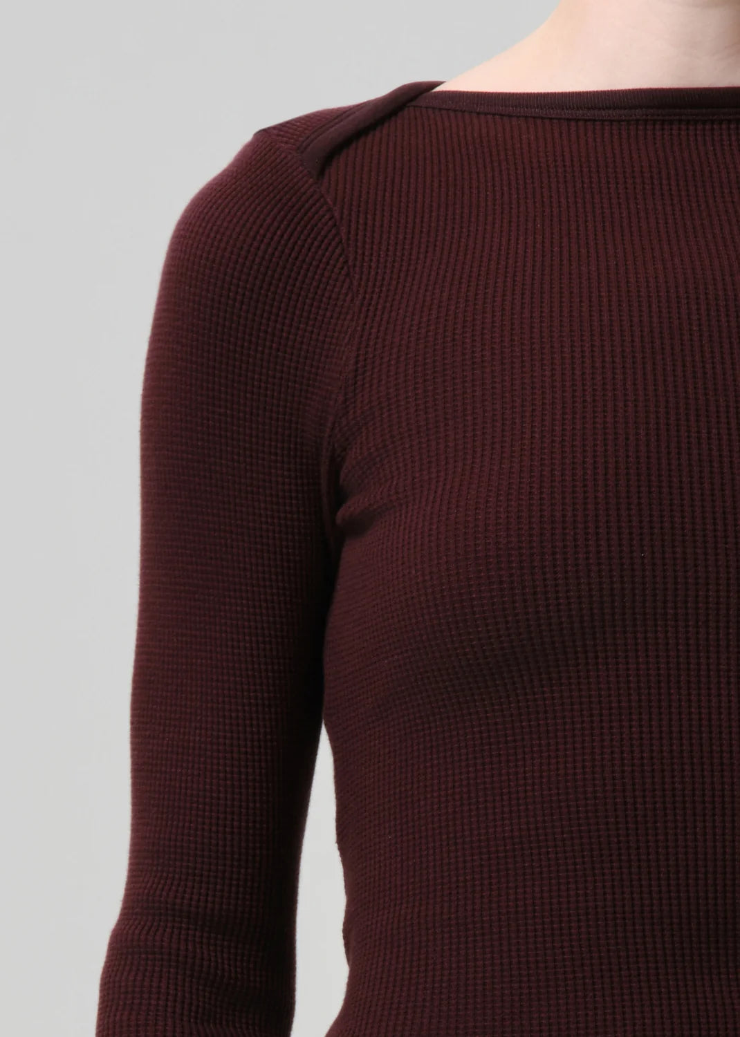 Brown ribbed sweater on a plain background