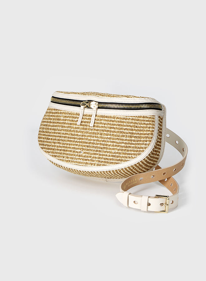 Gold woven belt bag on a light gray background