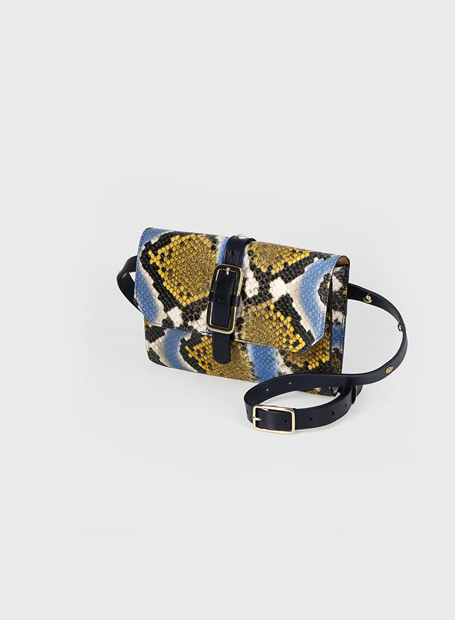 Patterned handbag with black strap on a light gray background