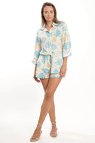 Woman wearing a floral outfit on a white background