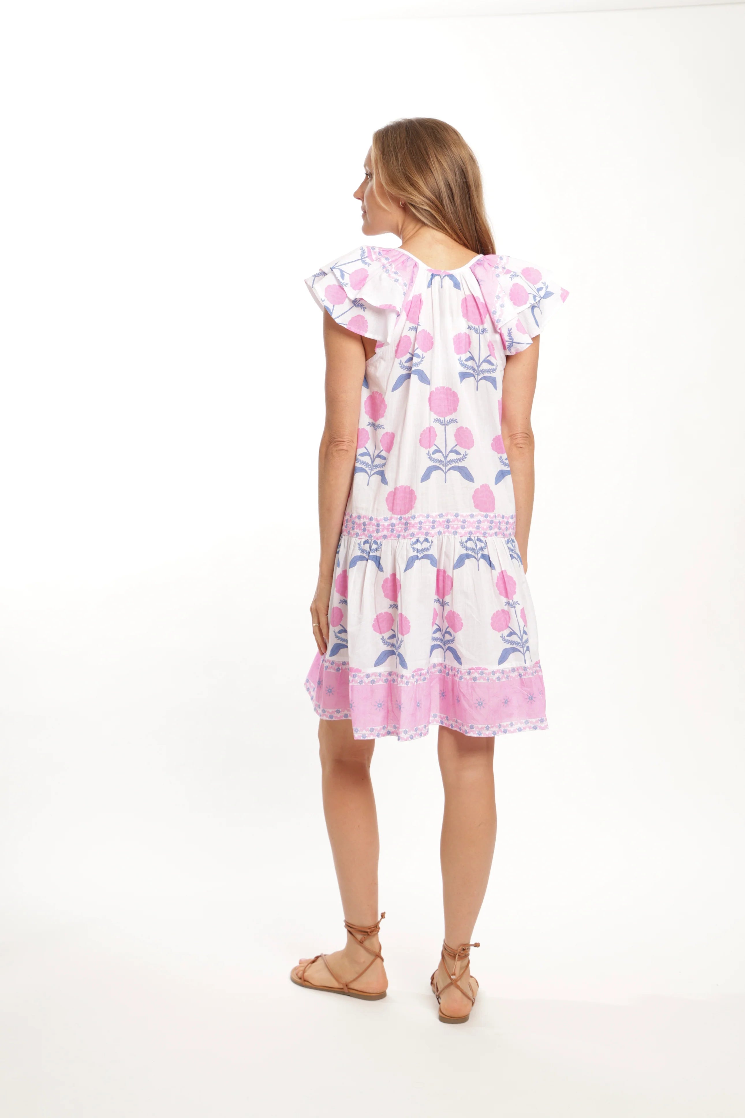 Woman wearing a floral dress on a white background