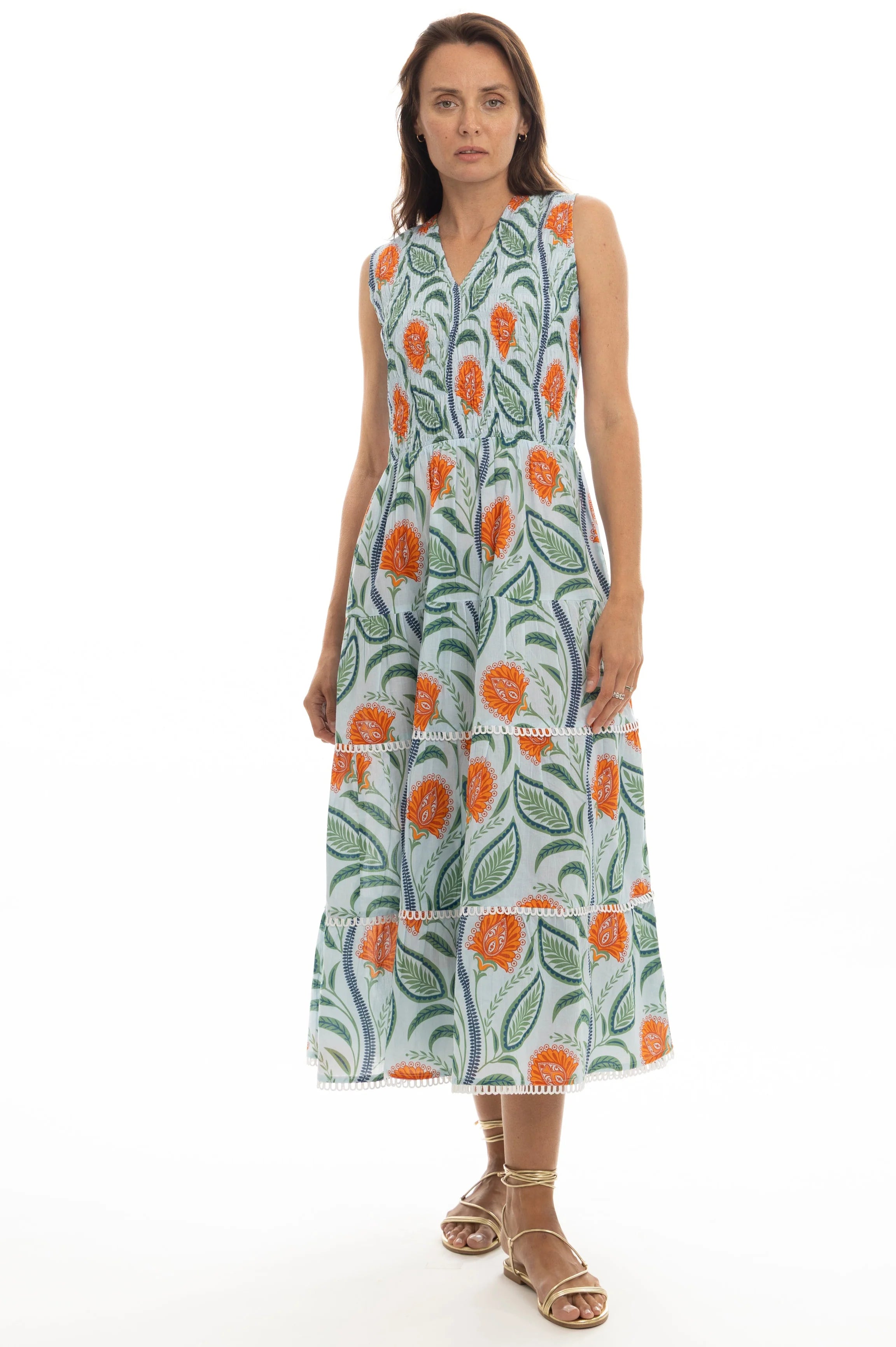 Woman wearing a sleeveless dress with floral pattern on a white background