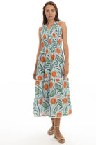 Woman wearing a sleeveless dress with floral pattern on a white background