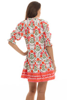 Woman wearing a floral dress with a white background