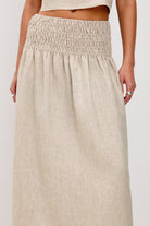 Beige skirt worn by a person on a white background
