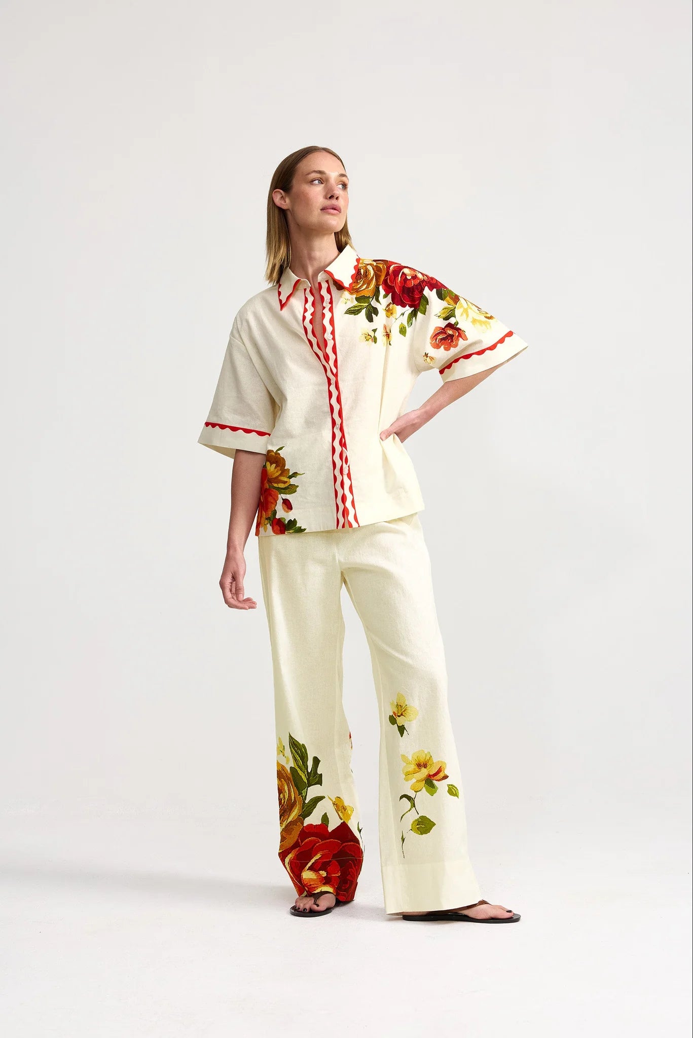Woman wearing a floral outfit with a white background