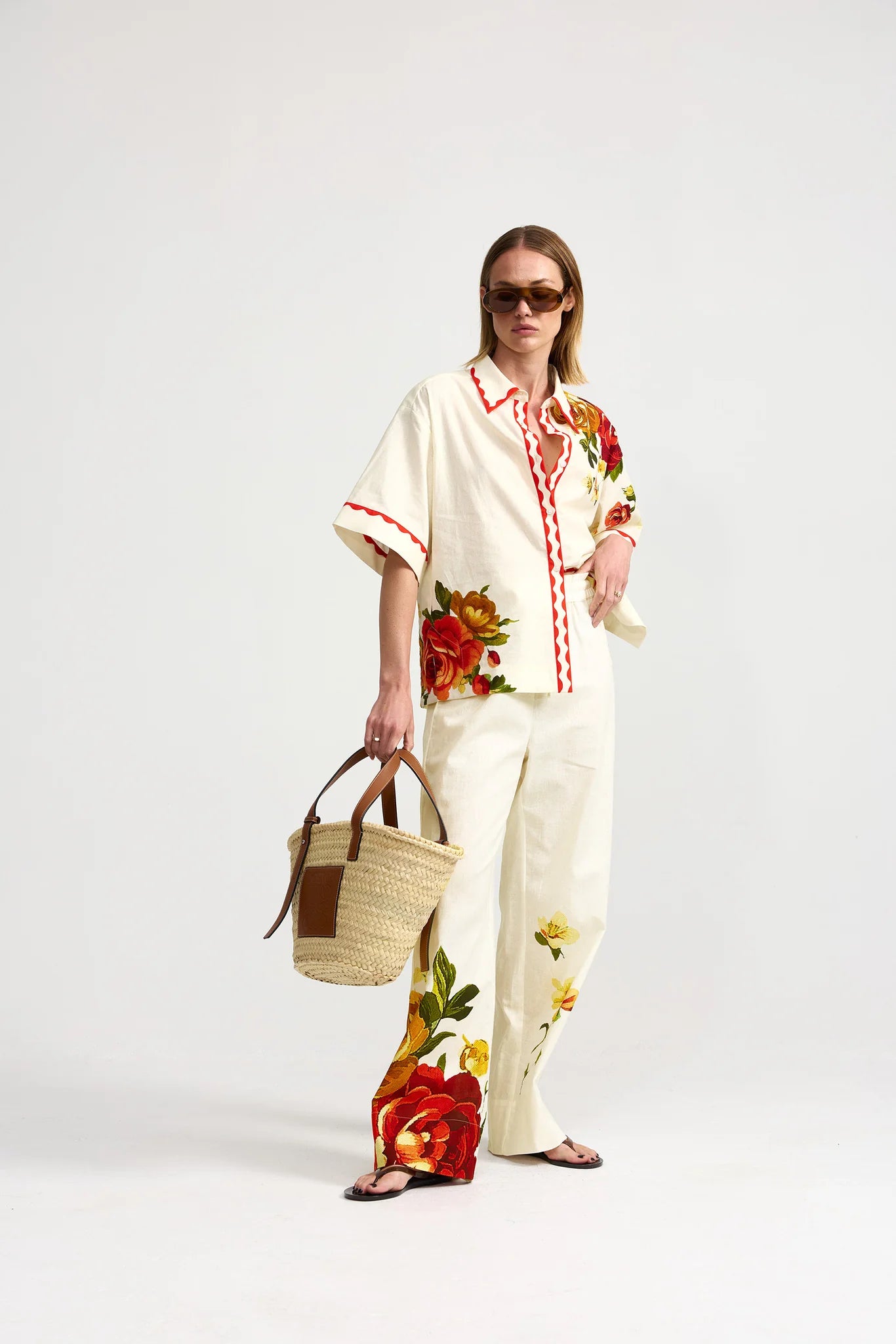 Woman wearing a floral outfit with a white background