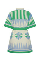 Person wearing a green and white striped outfit with a matching hat on a beige background