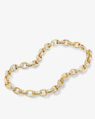 Gold chain bracelet with embedded stones on a white background