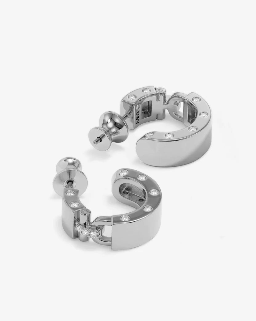 Pair of silver hoop earrings with small stones on a white background