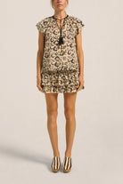 Woman wearing a floral dress with a plain background