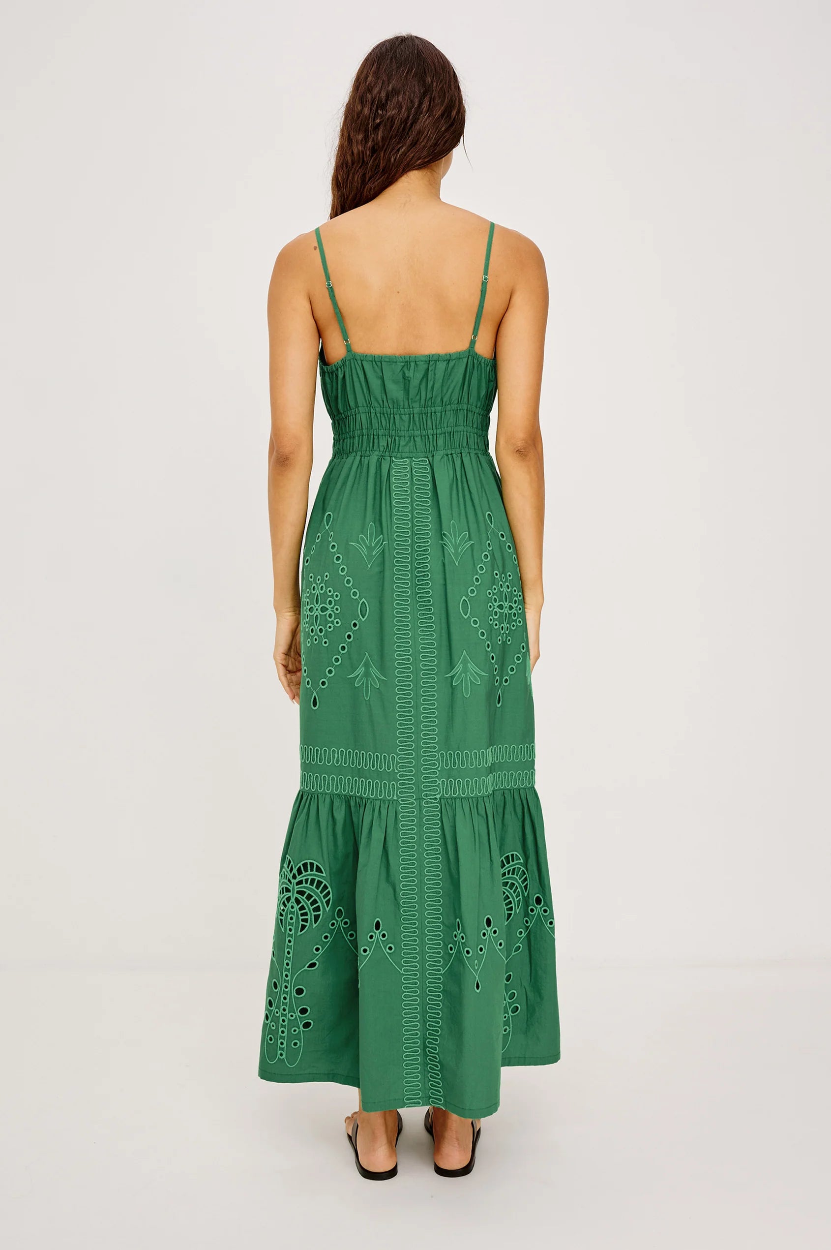 Green lace dress worn by a model on a light gray background