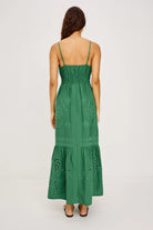 Green lace dress worn by a model on a light gray background