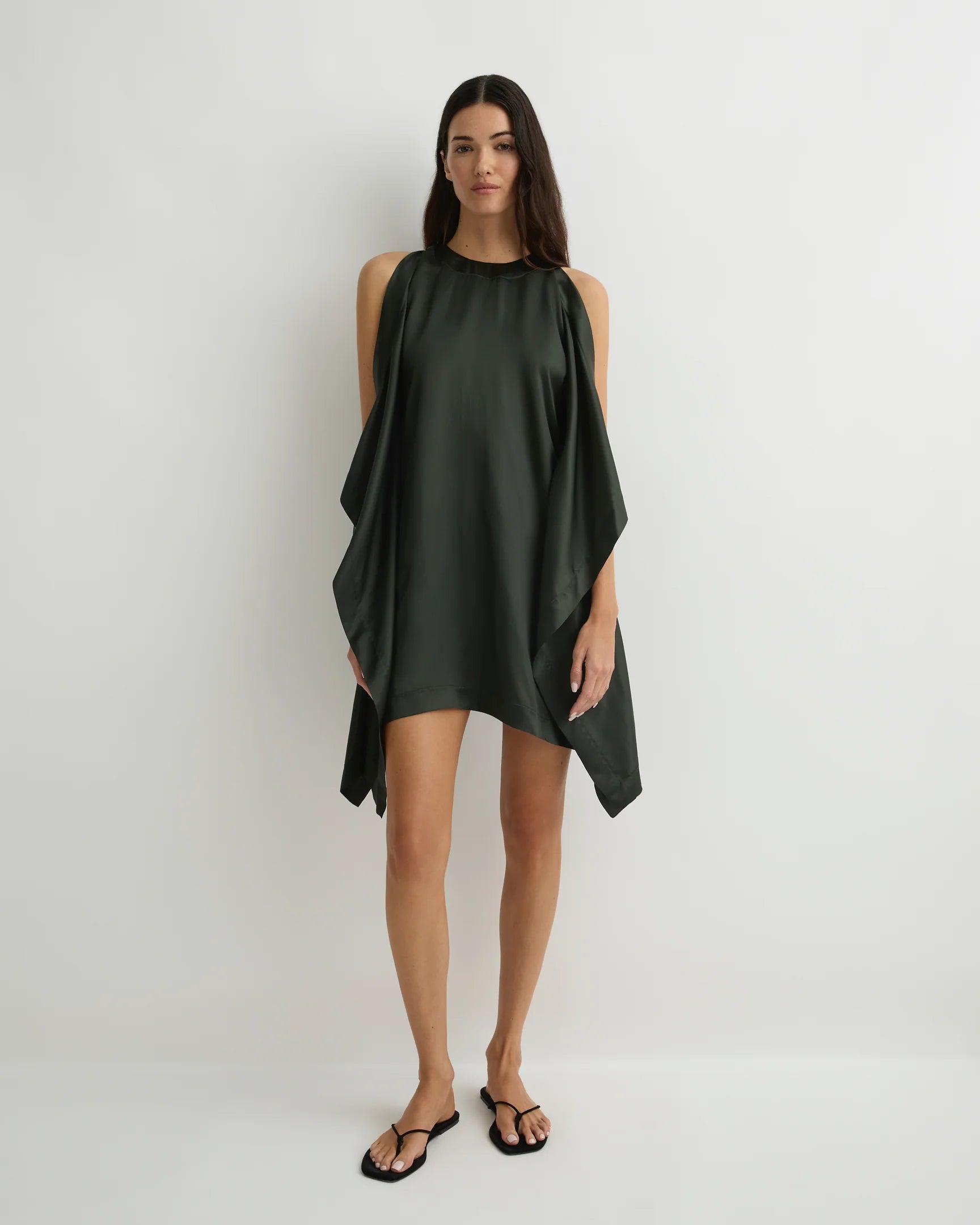 Woman wearing a dark green dress on a white background
