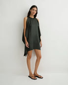 Woman wearing a green dress against a white background