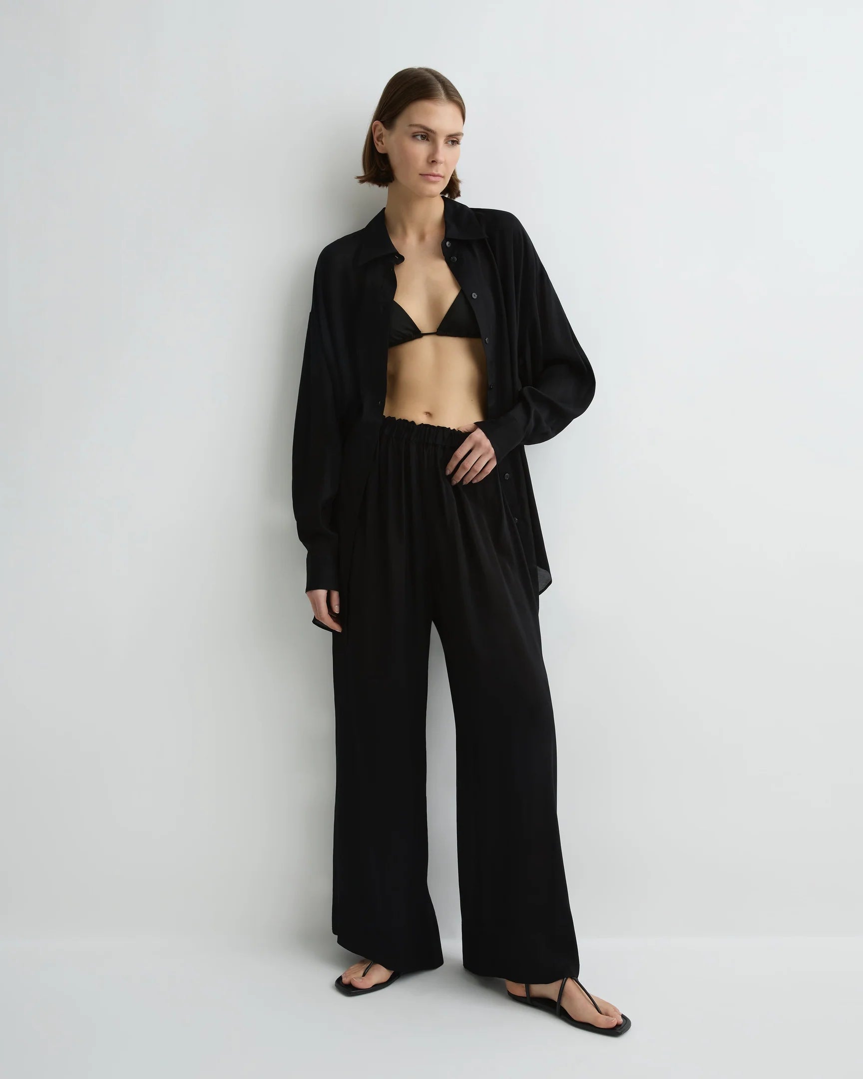 Woman wearing a black outfit on a white background