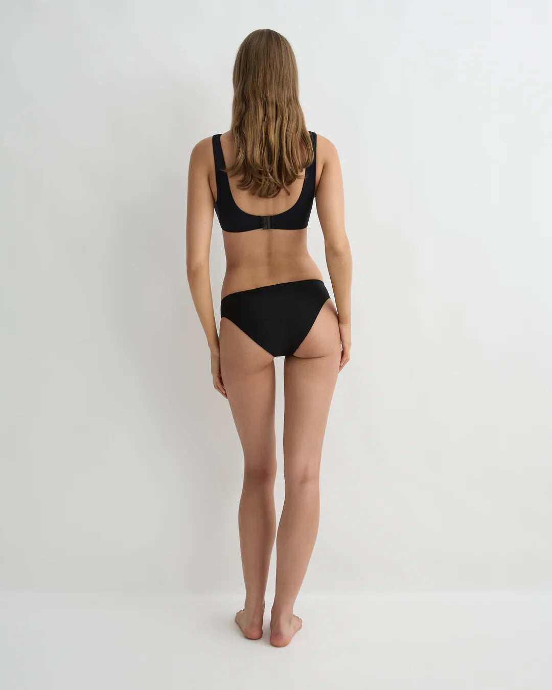 Person wearing a black bikini on a white background