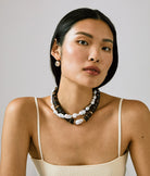 Woman wearing a necklace with a neutral background