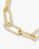 Gold bracelet with intricate design on a white background