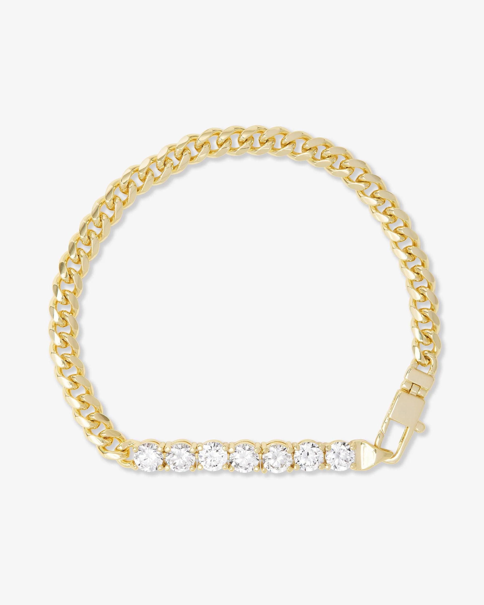 Gold bracelet with clear stones on a white background