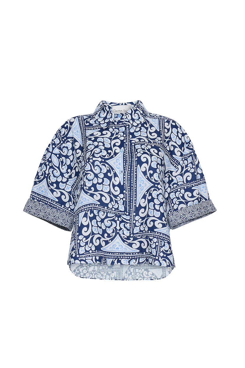Blue and white patterned blouse on a white background