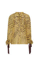 Yellow patterned blouse with long sleeves and tie details on a white background