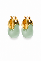 A pair of gold hoop earrings with smooth, curved light green stone-like drops, shown on a clean white background.