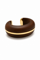 A chunky open cuff bracelet made of dark brown wood with a polished gold metal band running horizontally through the center, shown on a plain white background.