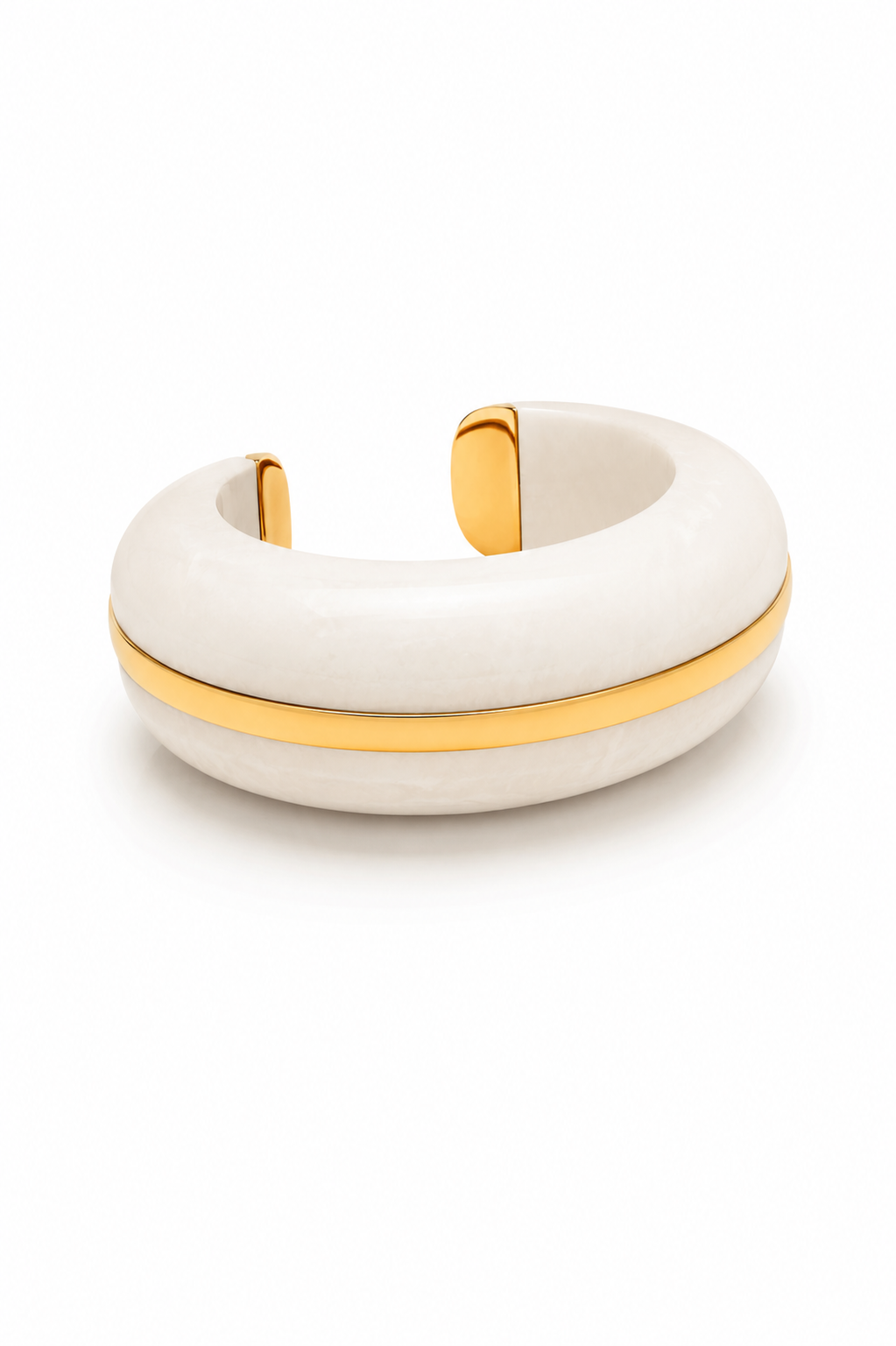 A thick, dome-shaped cuff bracelet made of textured off-white resin with a polished gold metal band running horizontally through the center and gold end caps, shown on a clean white background.