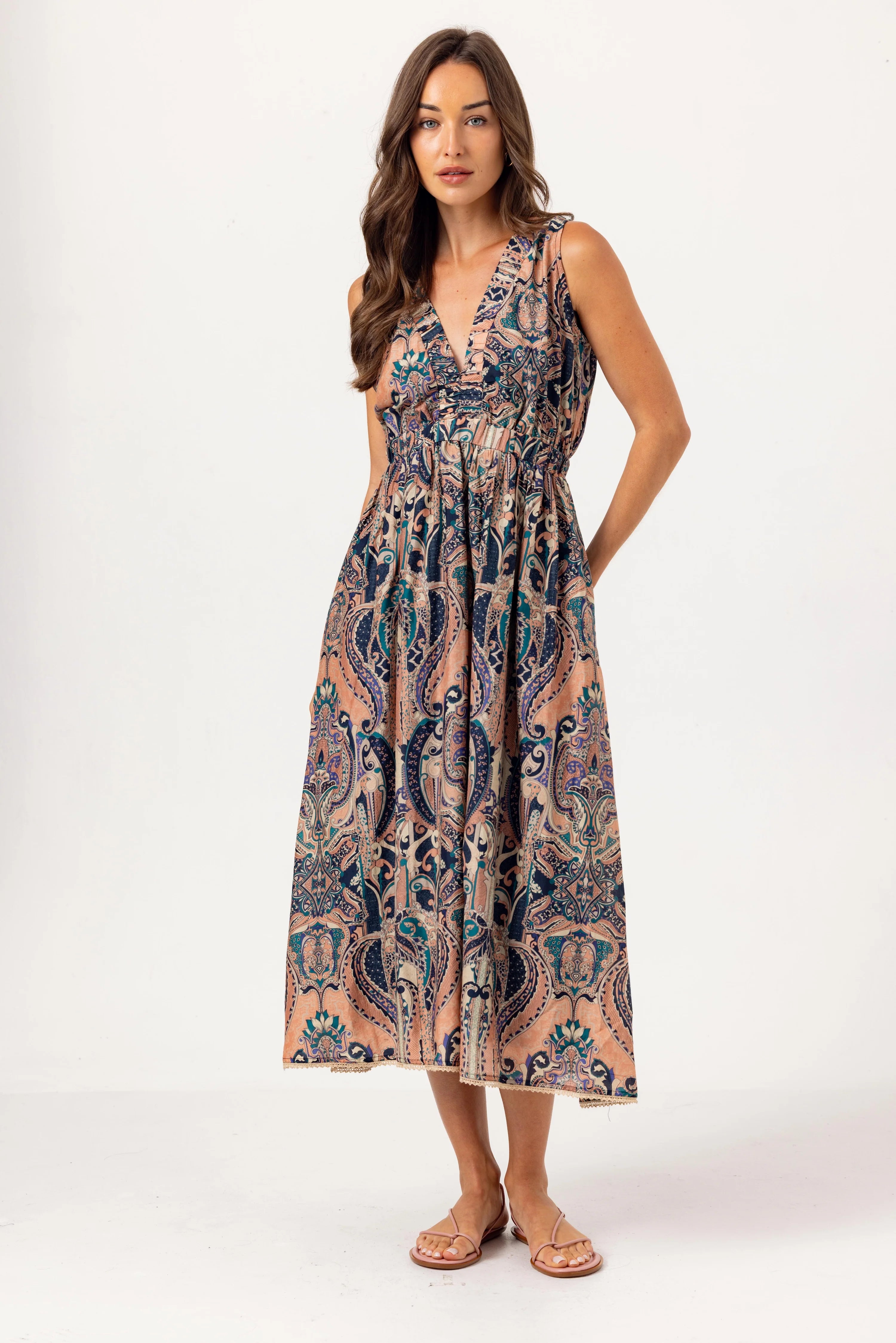 Woman wearing a patterned sleeveless dress on a white background