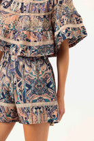 Patterned outfit with a top and shorts on a white background