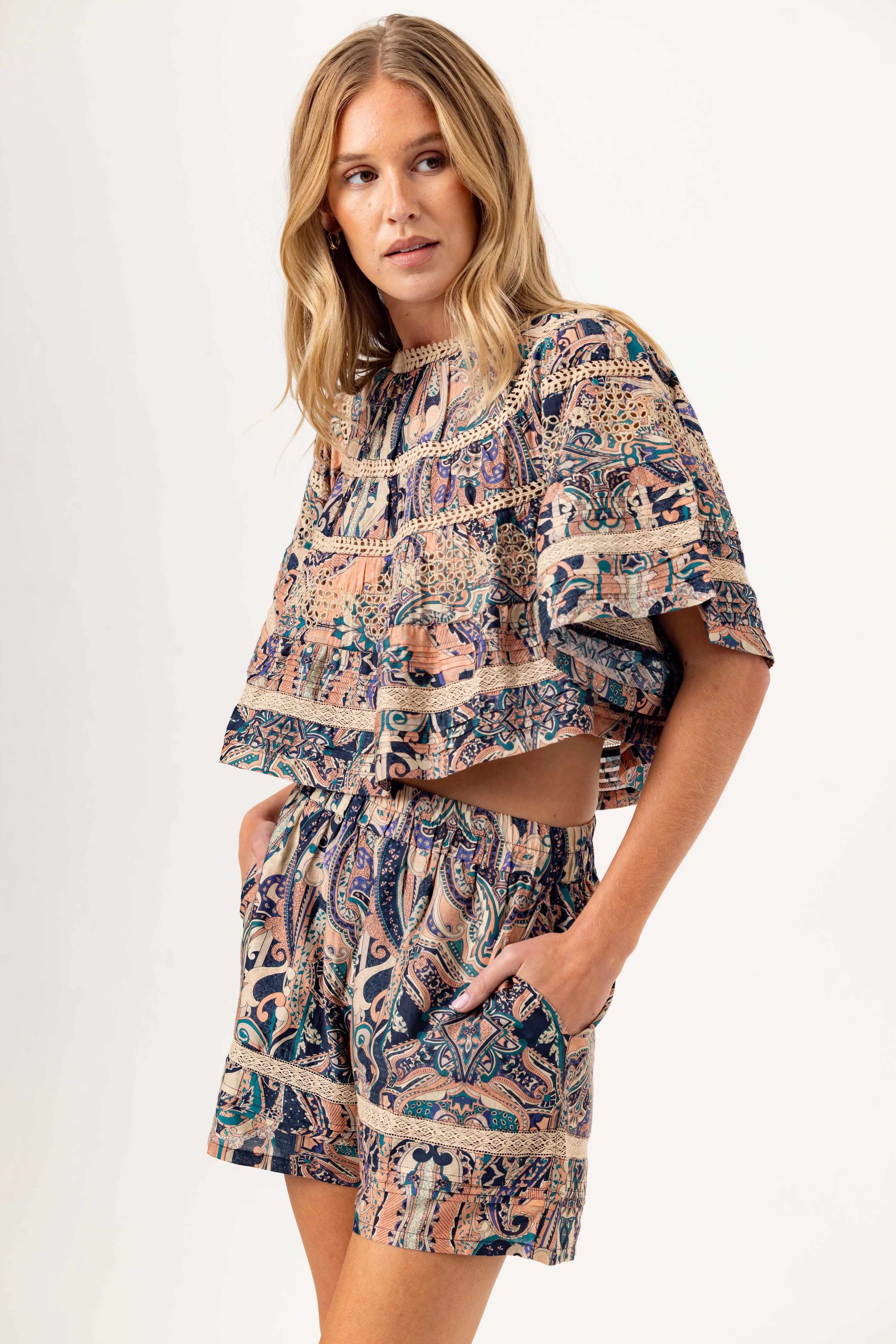 Woman wearing a patterned dress on a white background